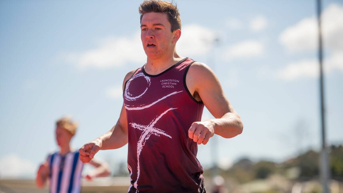 BOLD END: Launceston Christian School's Jonny Burk eases up over the finish line in the boys' open 200 metres. 