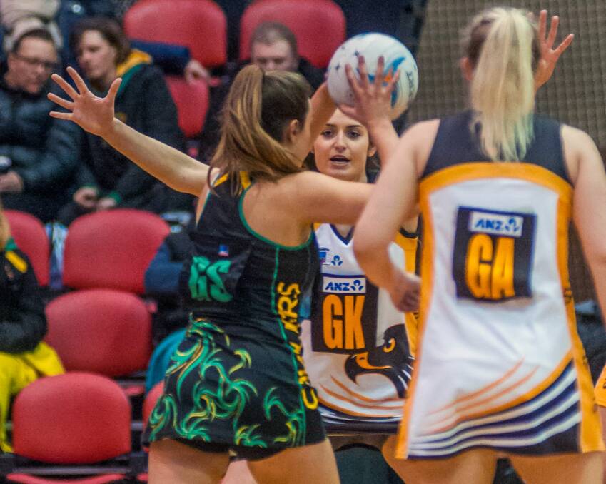 Cavaliers goal shooter Megan Harper looks to bypass Hawks defender Kate Hyland. Picture: Phillip Biggs