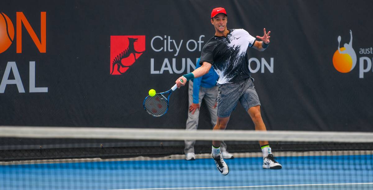 SMASHING: Andrew Harris takes it up to Andrew Whittington on Thursday during the all-Australian centre court clash at the Launceston International. Picture: Scott Gelston