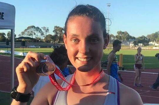 PROUD: Alice Randall holds up her Tasmanian bronze.