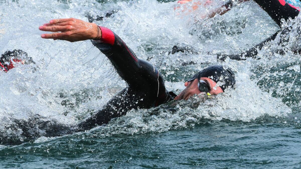 SPLASH DOWN: Jake Birtwhistle is just another face in the wash during the swim leg in the State Series race at George Town. Pictures: Neil Richardson