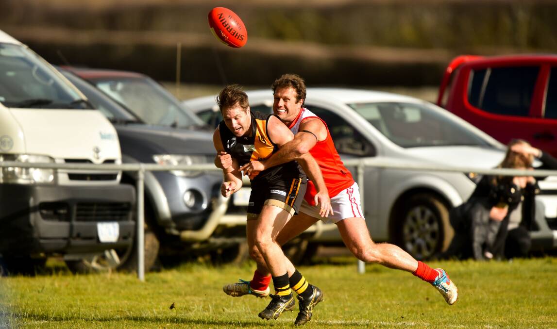 COP THAT: Brown forces the spill of the ball in his usual trademark aggression against Rocherlea.