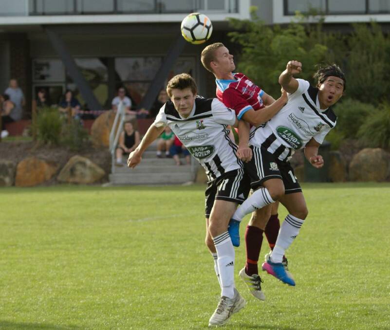 UP THEY GO: Launceston City and Northern Rangers collide in a high ball. Picture: Jamie Richardson