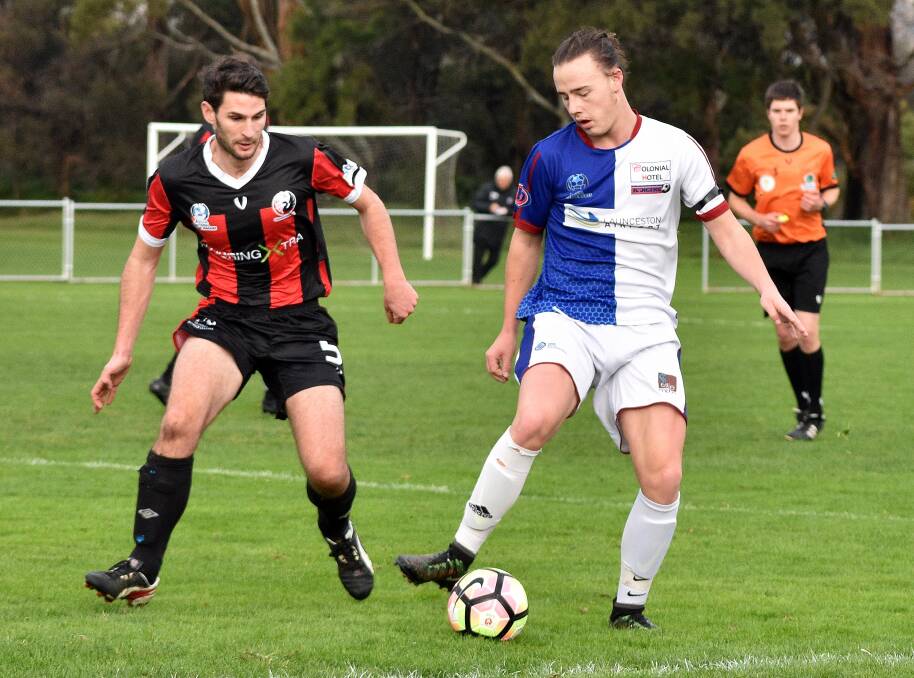 POSSESSION: Northern Rangers' Zachary Cross controls the play from Clarence United's Jonathon O'Neill. Picture: Walter Pless. 