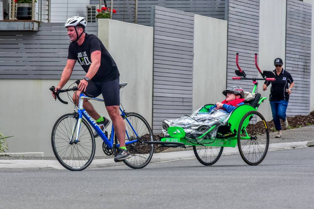 INSPIRATIONAL: Dad Chris Duffy pedals on for son Jack, who lives with cerebral palsy spastic paraplegia.