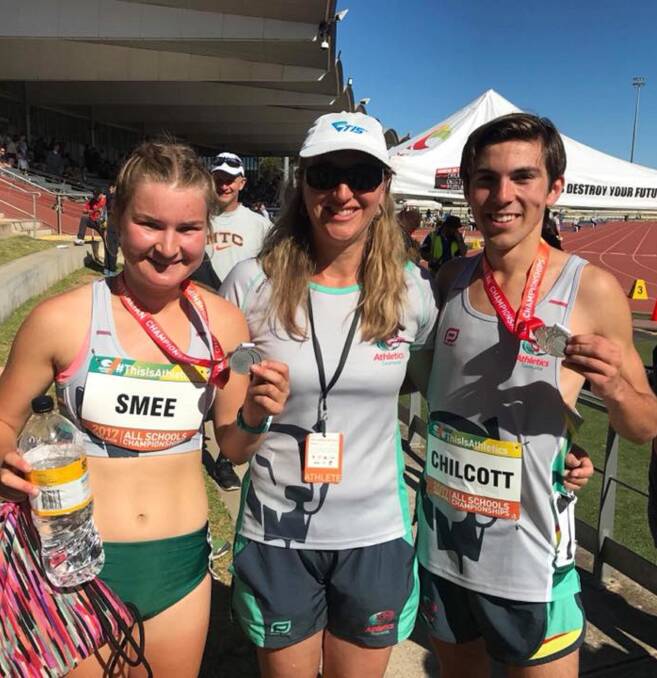 WELL DONE: Tasmanian Institute of Sport athletics coach Susan Andrews congratulates Ruby Smee and Harvey Chilcott on their medal success. Picture: Athletics Tasmania 