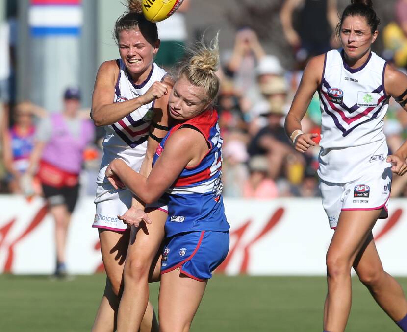 NO PRISONERS: Western Bulldogs rookie Daria Bannister lays a bruising tackle on Fremantle's Cassie Davidson in the AFLW match that resulted in injury. 