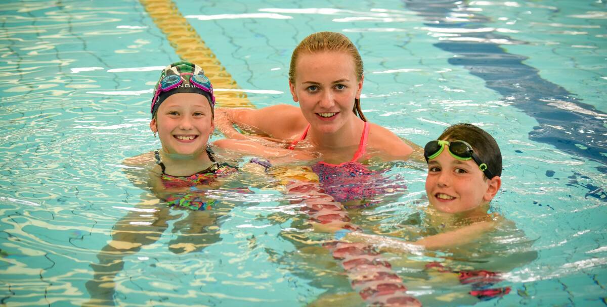 JUST LIKE ME: World championship medallist Ariarne Titmus recalls her early days in a Launceston pool with nine-year-olds Aibel Best and Charlie Arnold. Pictures: Paul Scambler