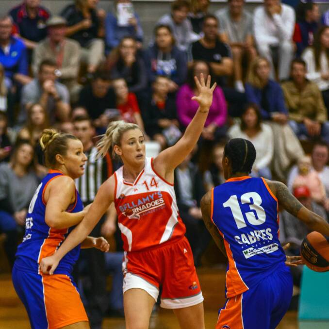 HANDS UP: Tornadoes forward Lauren Nicholson looks to stop the Sabres' attack. Picture: Phillip Biggs.