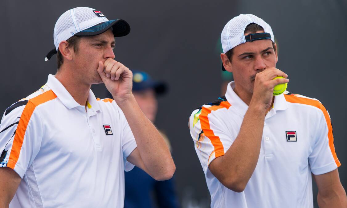 WHAT TO DO NEXT: Doubles pair Andrew Whittington and Andrew Bolt briefly discuss tactics between points during Saturday's doubles final loss. Pictures: Phillip Biggs