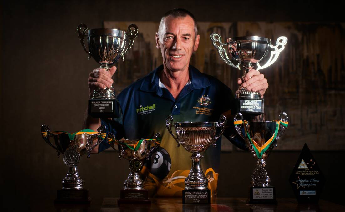 STOCKPILING: Devonport eight-ball master Wayne Stubbs shows off his latest world title silverware after returning from the UK. Picture: Phillip Biggs