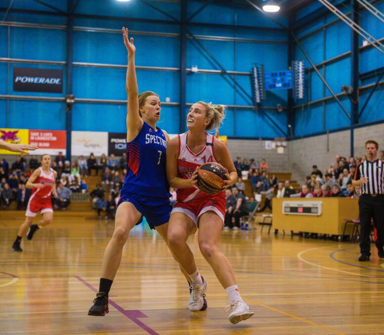 PRESSURE: Launceston forward Lauren Nicholson shows determination to get past the Nunawading defence at Elphin Sports Centre. 