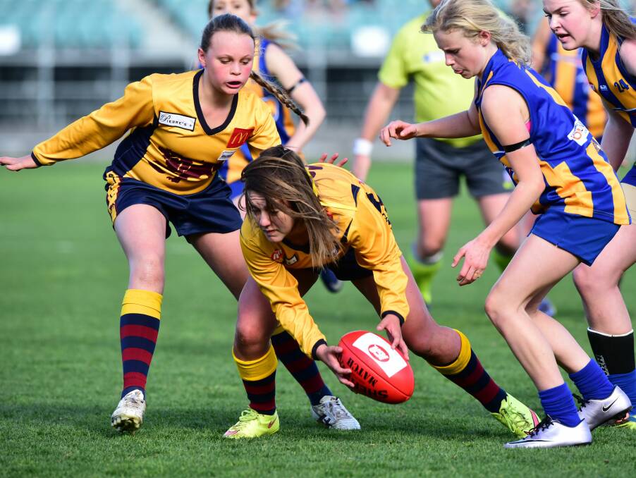 GIRLS YOUTH: East Launceston's Amy Halaby picks up the ball cleanly amid the Lions' triumphant flag win over Evandale. Picture: Neil Richardson 