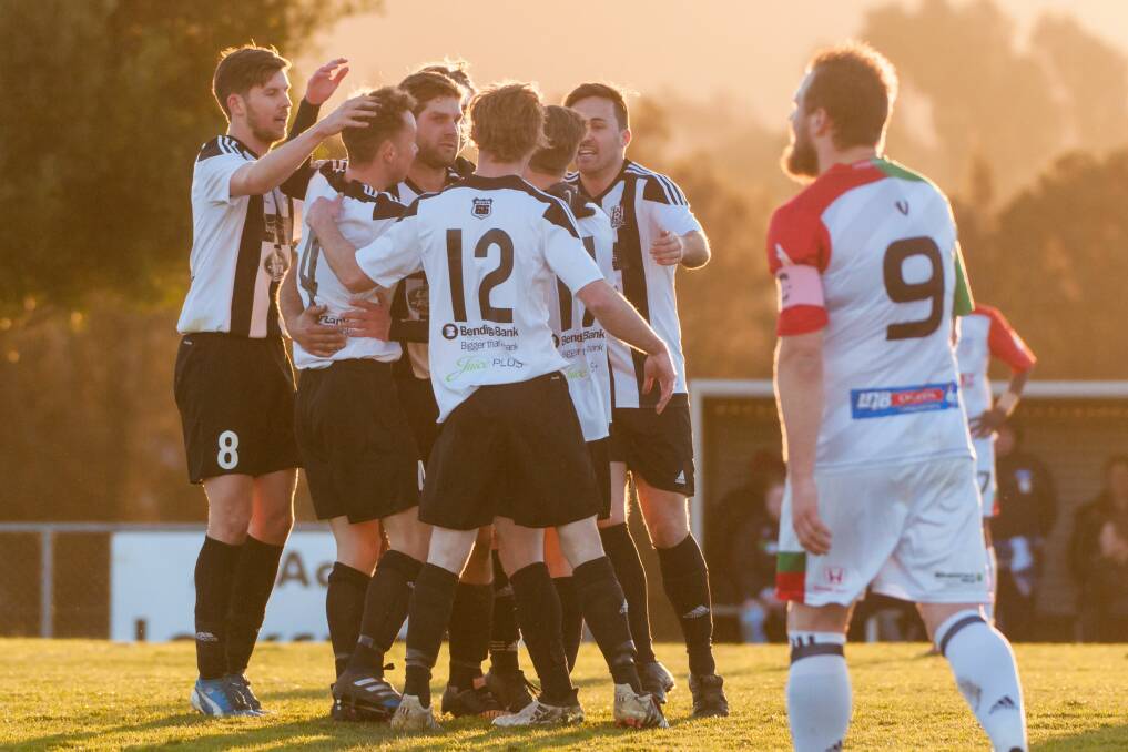 GET AROUND US: Launceston City players celebrates an early goal over Hobart Zebras that secured a fourth win in a row in the Saturday twilight game. Picture: Phillip Biggs