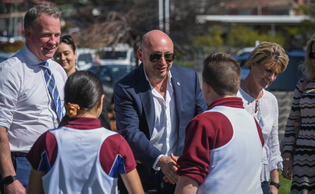 GREETINGS: NBL boss Larry Kestelman meets Riverside Primary School students with the Tasmanian Premier Will Hodgman. Picture: Paul Scambler