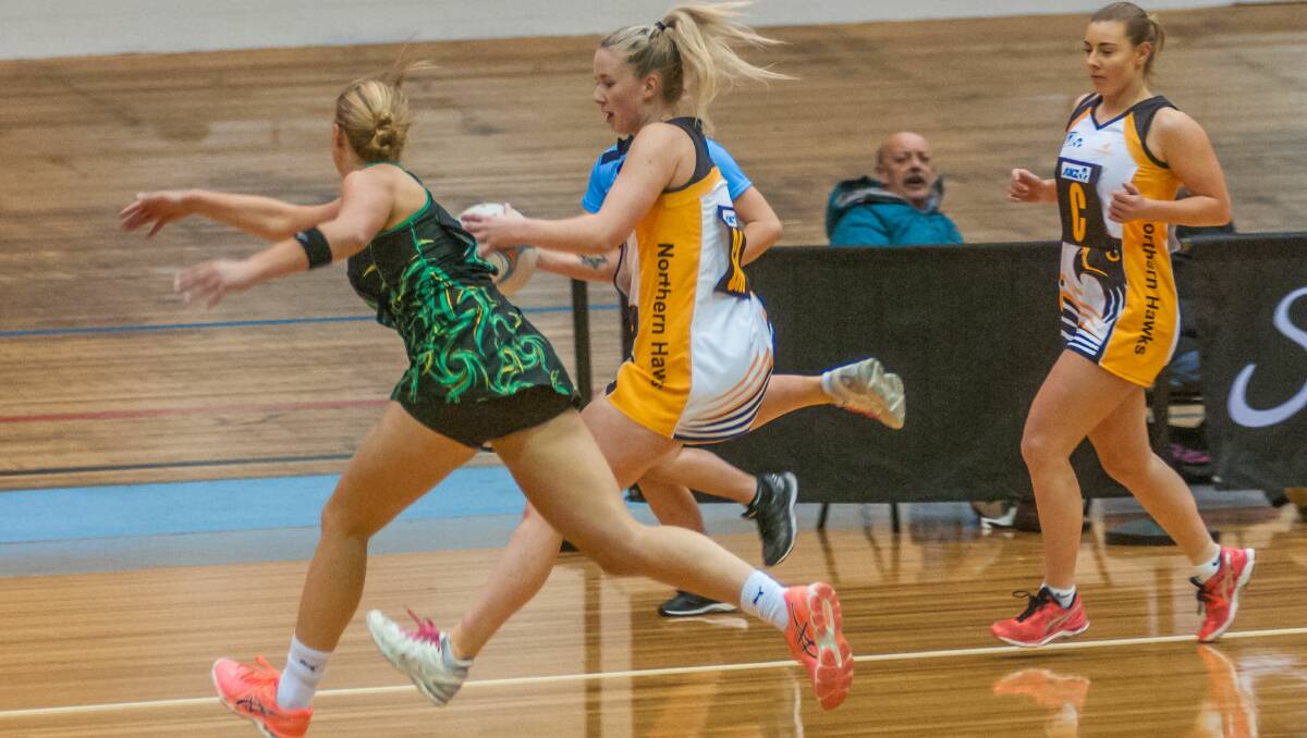JUST IN TIME: Northern Hawks' Zoe Claridge wins the race for the ball in the Launceston state league derby against Cavaliers on Friday night. Picture: Phillip Biggs