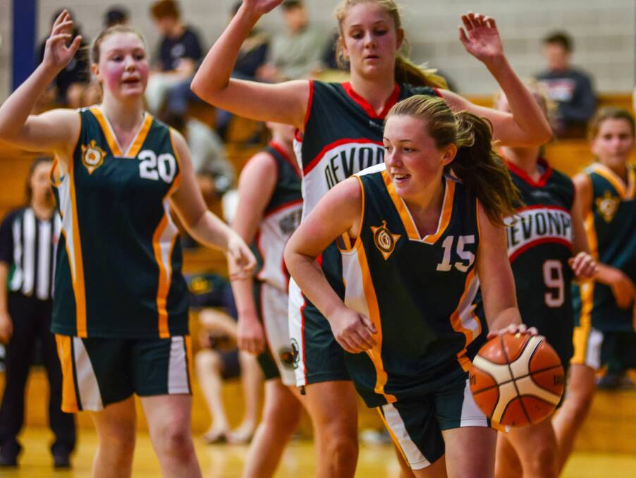 ALL SMILES: St Patrick's College Launceston student Sophie Ackerly happily weaves around the defence.