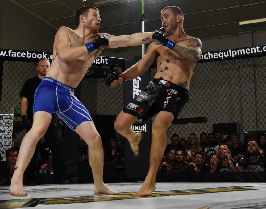 BLOW: Damon Upton-Greer pulls a left strike on adversary David Butt in Saturday night's MMA main event at the Polish Hall. Picture: Scott Gelston 