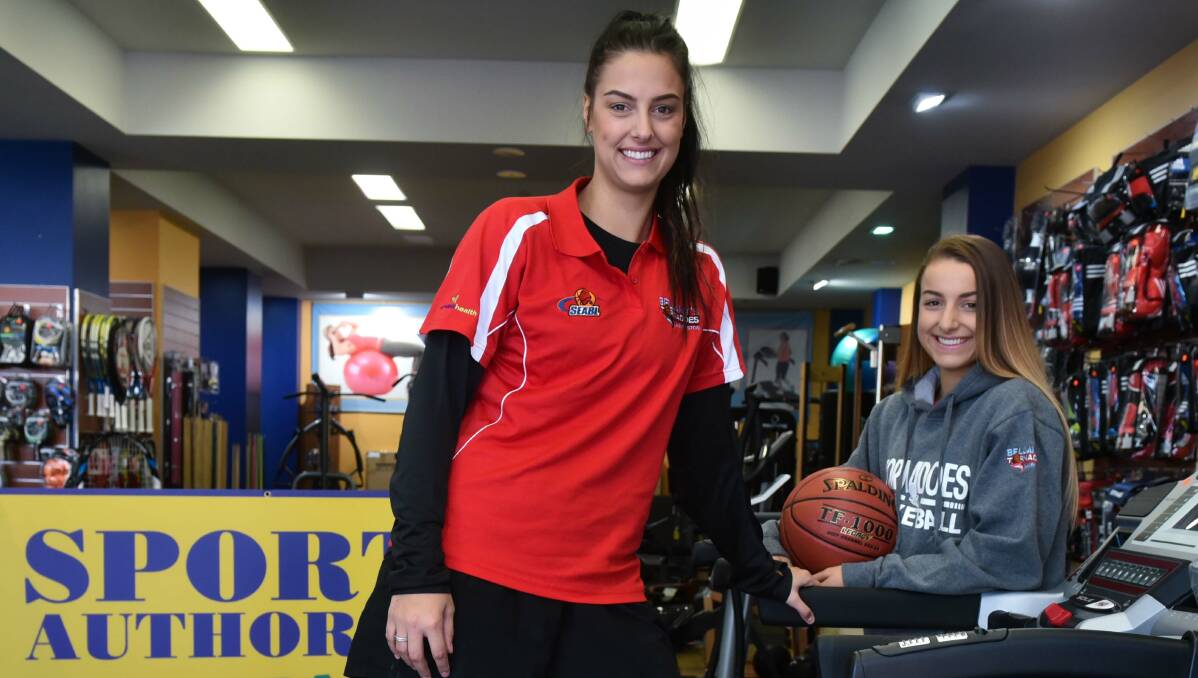SISTER LOVE: Olivia Chugg is greeted at her job by sister Nina Howard (right) on reaching 100 SEABL games for the Launceston Tornadoes. Picture: Neil Richardson.