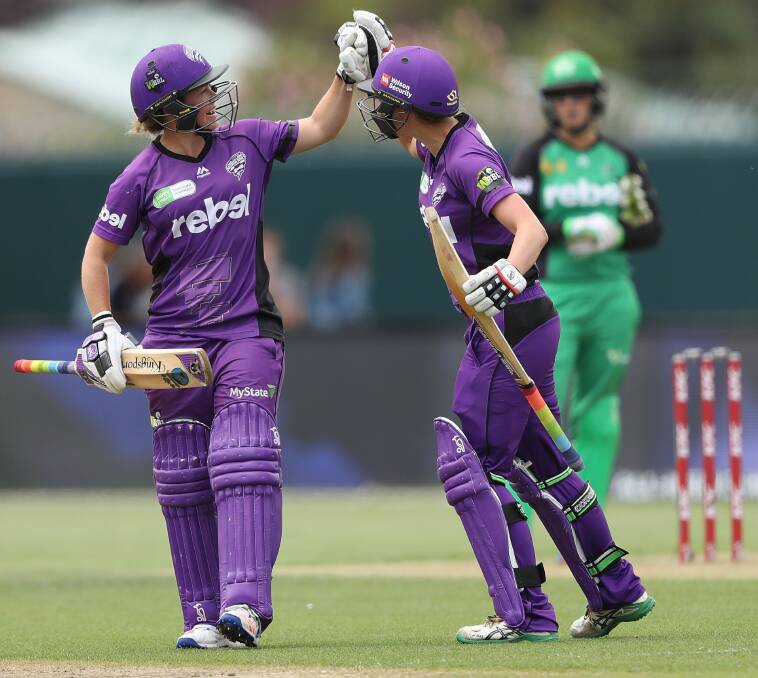 COOL AS: Corinne Hall and Emma Thompson exchange high fives after the penultimate-ball win against the Melbourne Stars. Picture: Getty Images