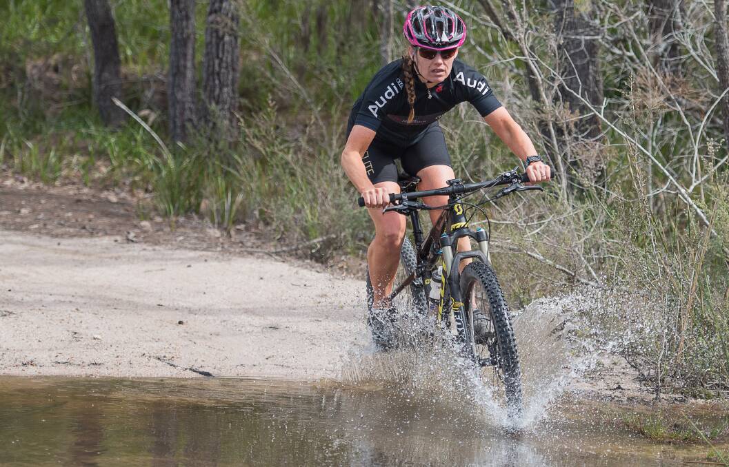CAUSING A SPLASH: Launceston competitor Sally Alps showing great form on the bike on her way towards capturing the Freycinet open women's event this year. Pictures: Clive Roper