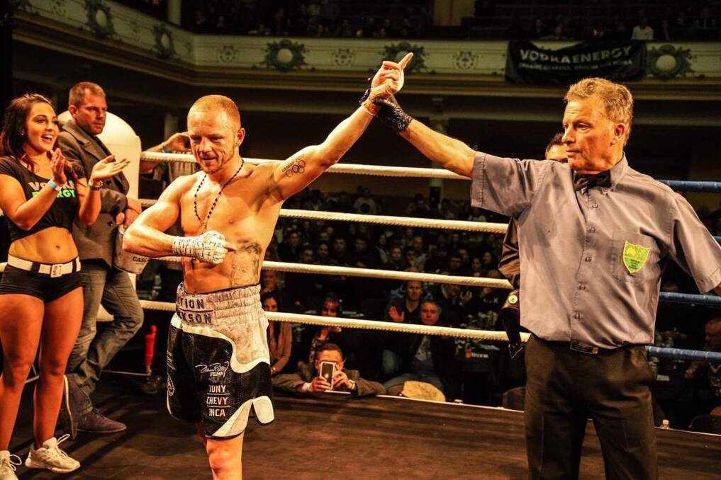 STANDING STRONG: Tasmanian Luke Jackson has his hand raised after defending his title belt in a points-decision win on Saturday night in Hobart. Pictures: Black Snow Images
