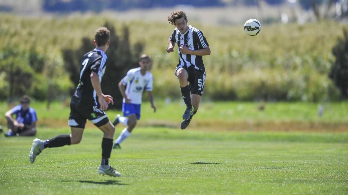 UP AND GOING: Launceston City's Rhys Goold connects in mid-air in the NPL Summer Series soccer battle against Olympia at Windsor Park on Saturday. Picture: Scott Gelston
