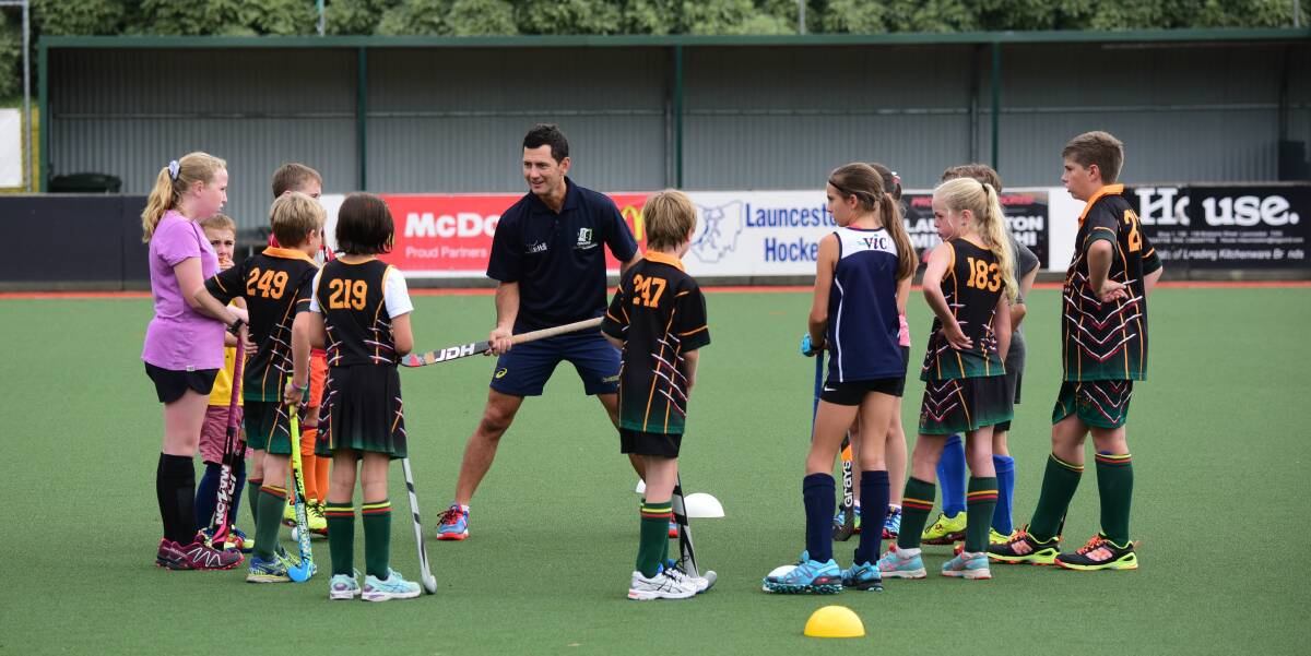 HERE'S THE WORD: Retired Australian hockey champion Jamie Dwyer spreads the sport's gospel to enthusiastic Launceston youngsters on Thursday. Picture: Paul Scambler