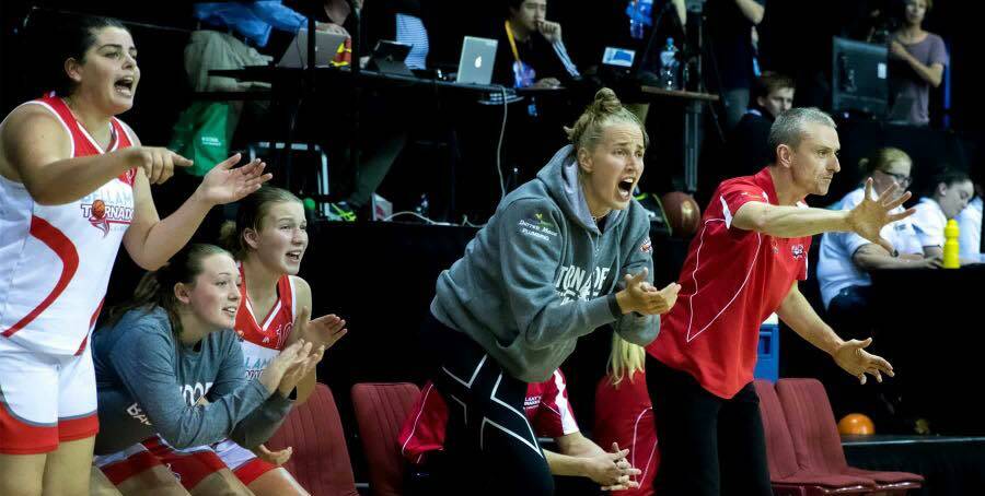TEAM PLAYER: Mikaela Ruef, standing alongside new Tornadoes coach Ben Rush, shouts out encouragement to her former teammates from the sidelines in the club's opening SEABL game of the season against Hobart Chargers.