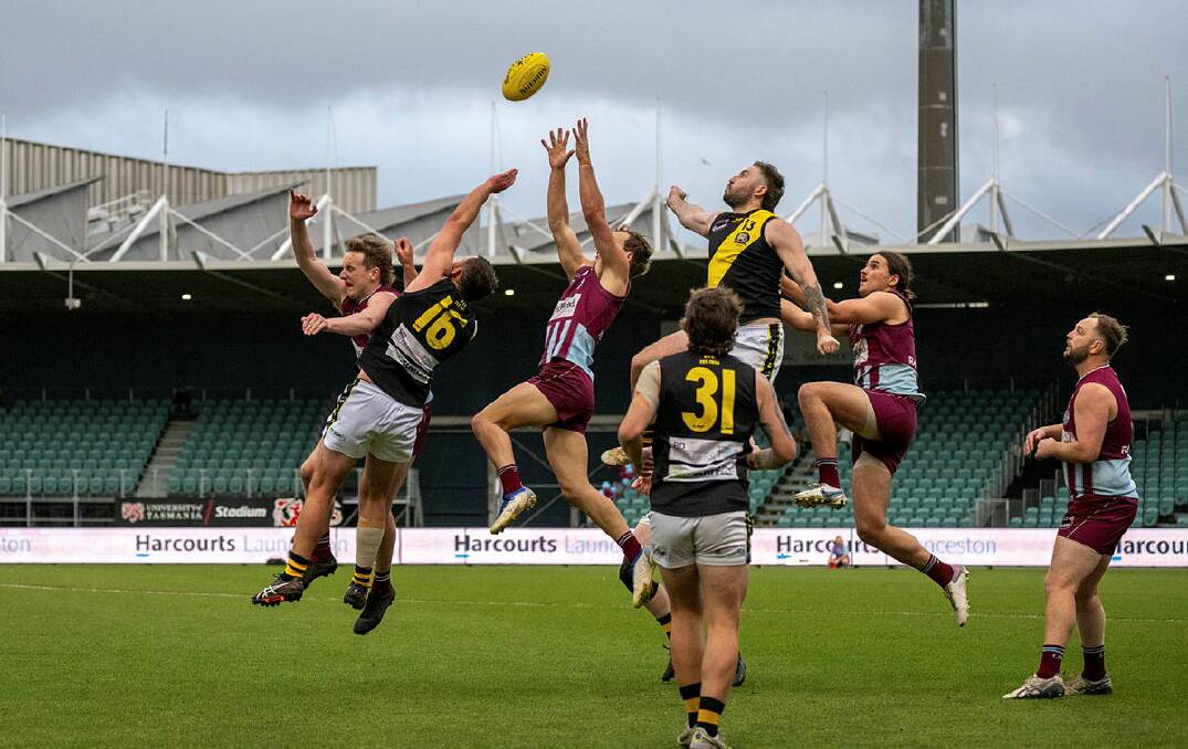 Hillwood and Rocherlea players fly high for the ball during the NTFA premier 2023 grand final at UTAS Stadium. Picture by Paul Scambler 