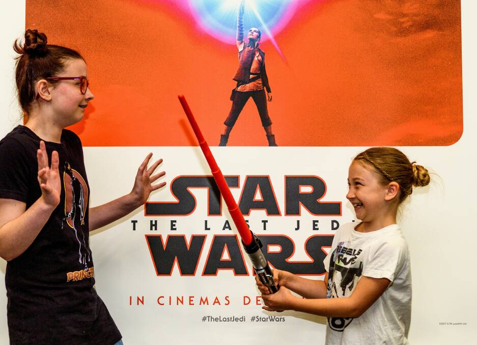 Biggest fans: Arwen, 13, and Myfanwy Porter, 10 at Village Cinema after catching the latest Star Wars flim on the opening day. Picture: Scott Gelston.