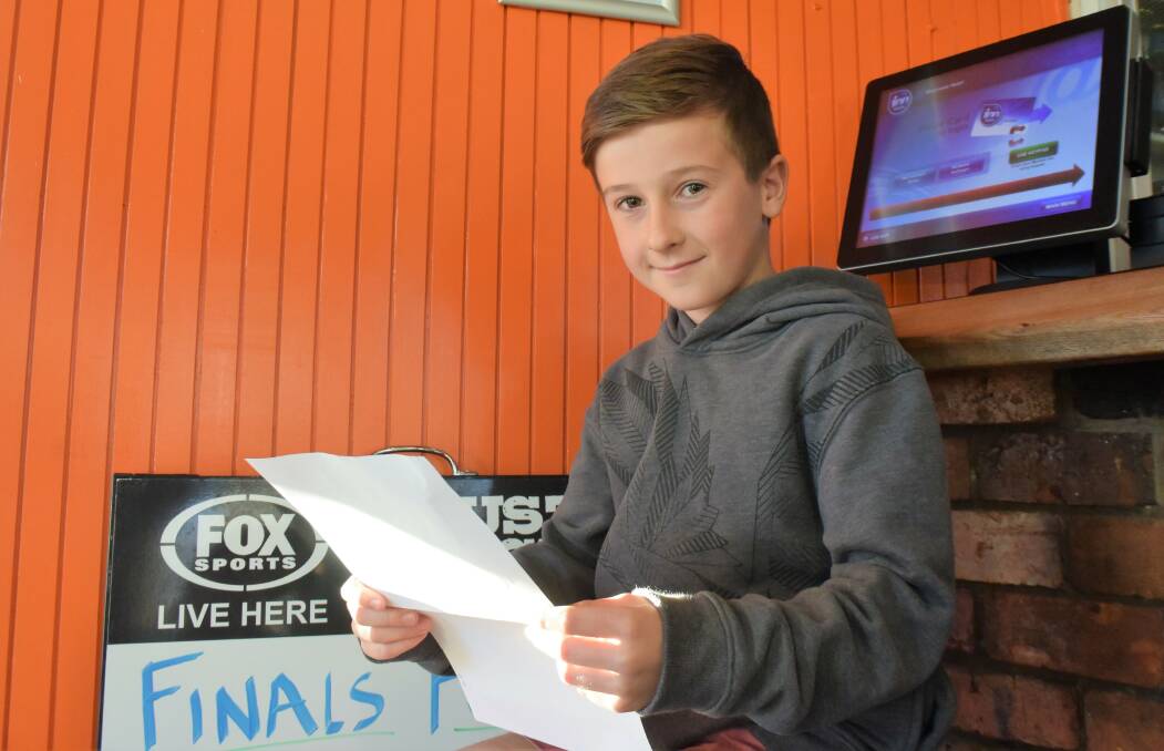 Winner: Jaxon Owens, 9, received his congratulatory letter and cheque for $13,500 from Sportspick at the Riverview Hotel after winning a national footy tipping competition. Picture: Lucy Stone
