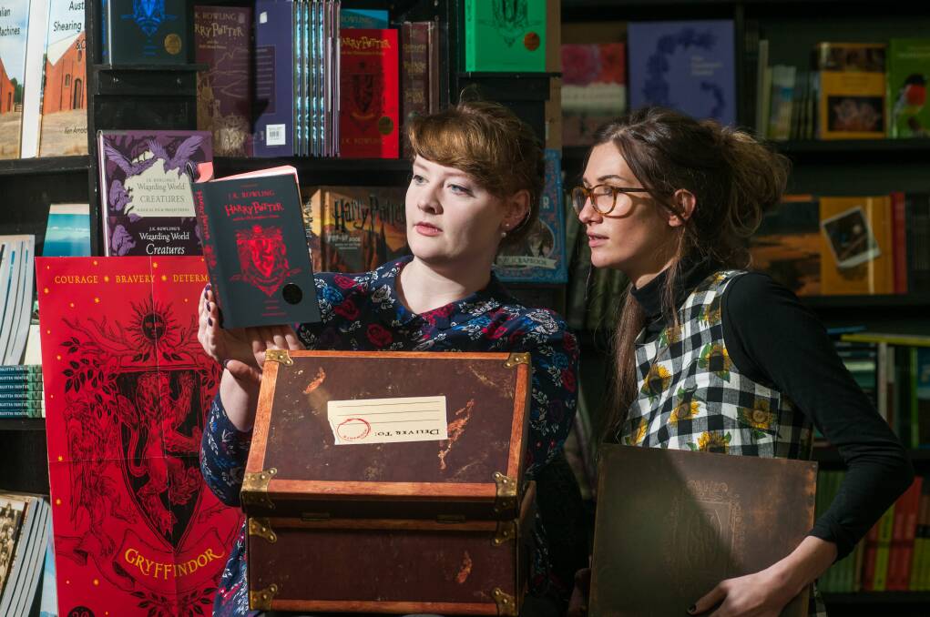 Gryffindor: Clarissa Mills and Abby Saunders with the anniversary edition of Harry Potter and the Philosopher's Stone. Picture: Phillip Biggs