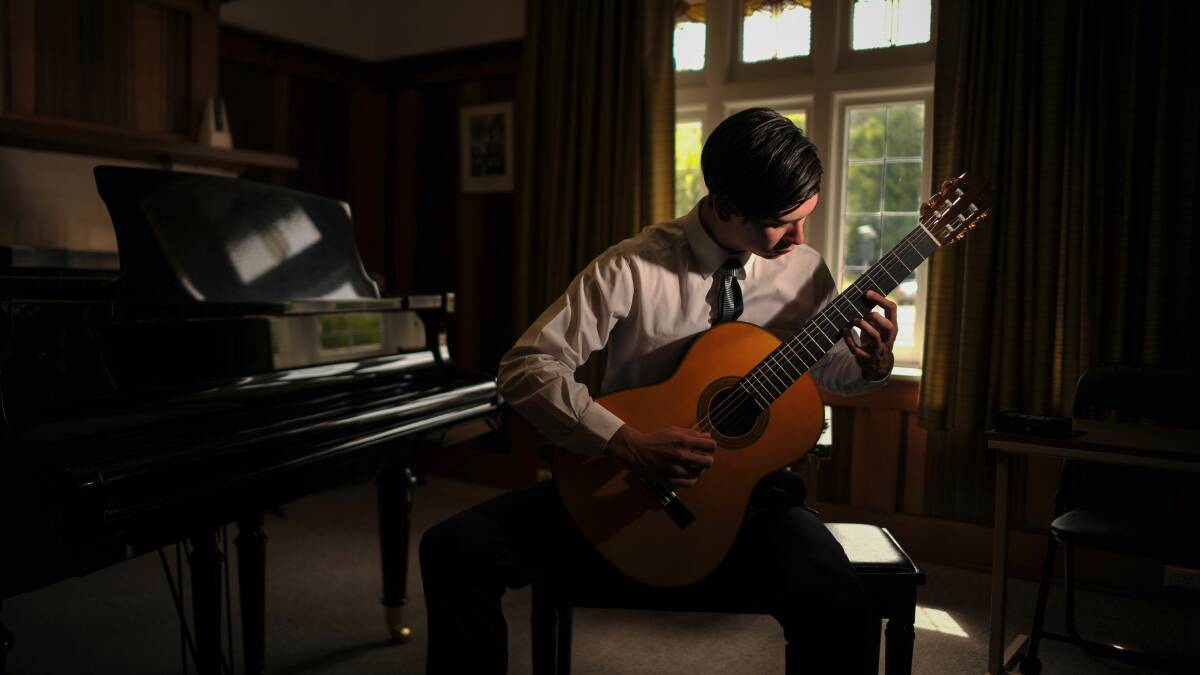 Making a study: St Cecilia School of Music classical guitarist Patrick Chilvers plays a piece in the school's Launceston headquarters, before he heads to Hobart to commence medicine studies at UTAS. Picture: Scott Gelston