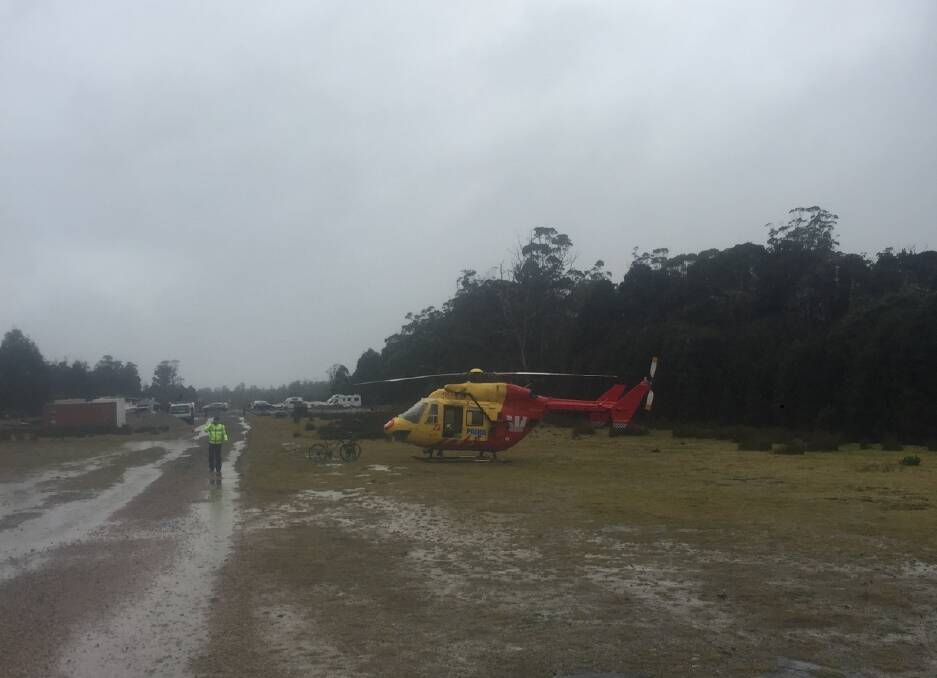 The Westpac Rescue Helicopter on stand-by at Cradle Mountain waiting for a break in the weather to reach the walker. Picture: Supplied