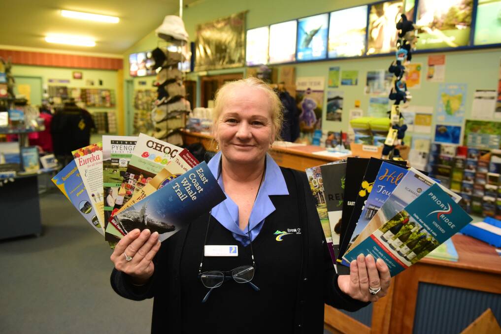 Break O'Day customer service officer Debra Taylor with some of the pamphlets offering tourist experiences across the East Coast. 