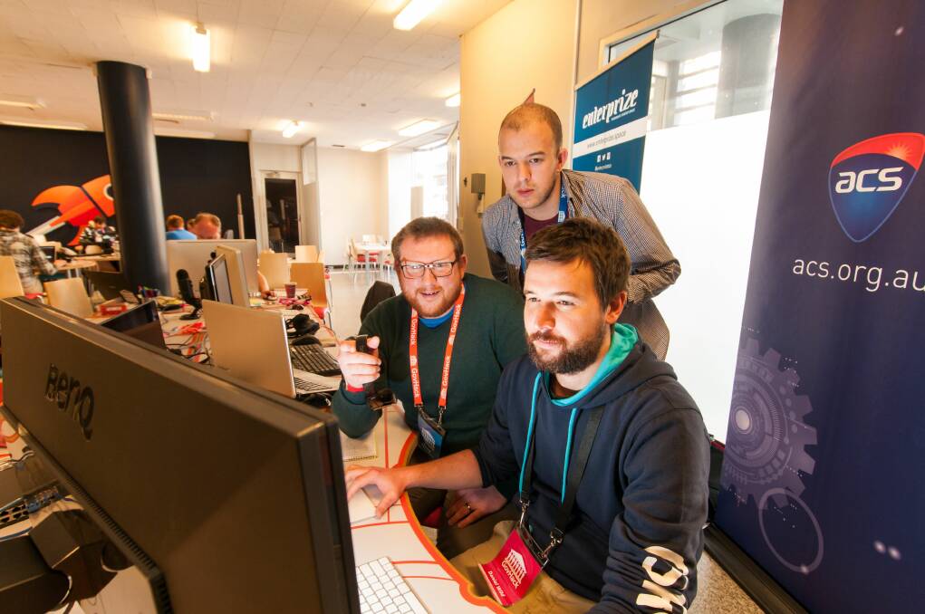 TEAMWORK: MRaw Data team members Dan Richardson, Justin Hood and  Dan Wild working on their app. Picture: Phillip Biggs.