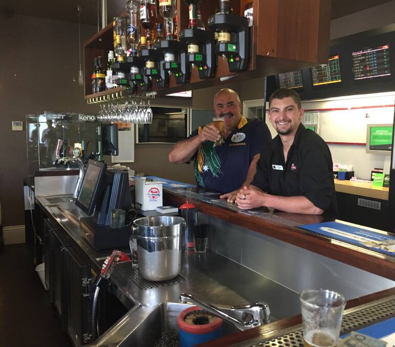 CHEERS: David Foster has a beer with Deloraine Hotel staff member Cameron Hope. Picture: Stefan Boscia