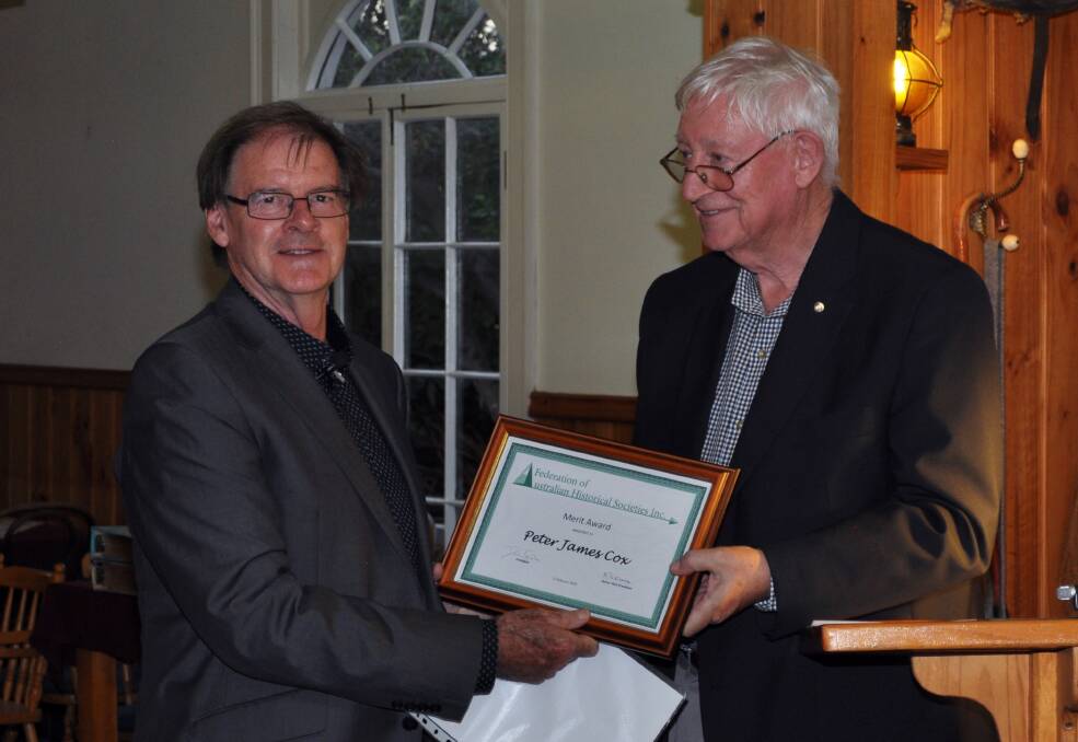 AWARD: FAHS president, and associate professor at the University of Melbourne, Don Garden hands Peter Cox the FAHS Award of Merit. Picture: Supplied
