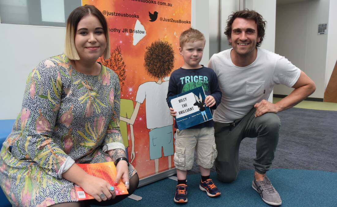BOOK IT IN: St Giles behavioural support therapist Sara Wright (left) and children's book author Tim Bristow (right) with four-year-old Liam Goninon. 
