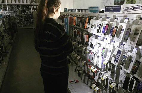 Hayley Webster shops for torches after a power outage affected areas of Invermay, Mowbray and Launceston.