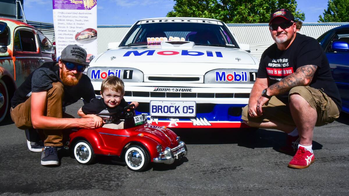 LEGENDARY MUSCLE: Josh Nielsen with son Kayden, 3, and Michael Mitchell with his Brock machine at UTAS Stadium. Picture Neil Richardson