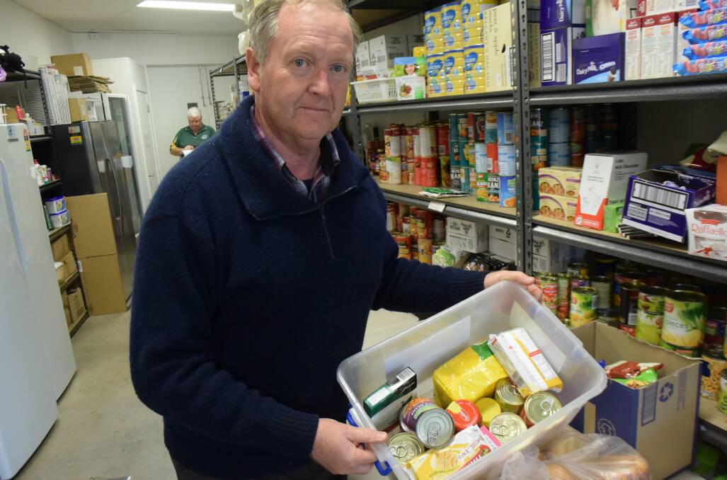 HELPER HAMPER: Robin Boag with one of the food packages used by the Benevolent Society.