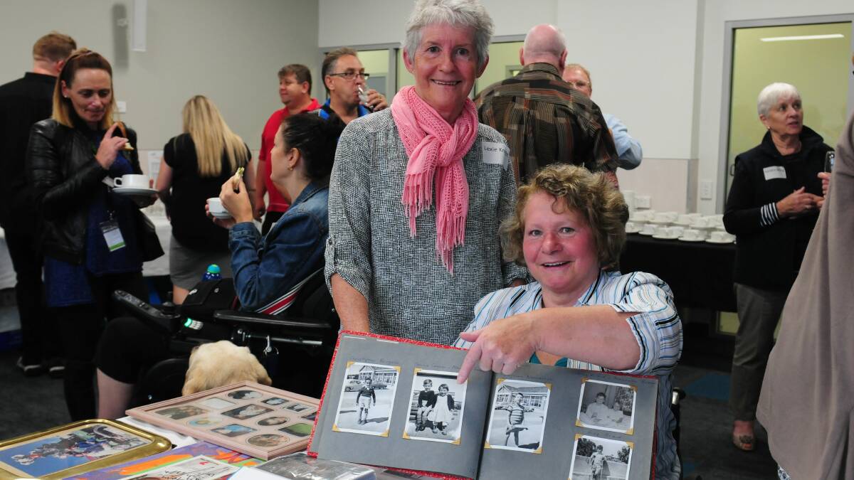 REUNION TO REMEMBER:  Lexie Knight of Scottsdale and Maureen Green of Devonport look through an old photo album at the StGiles reunion on Friday. Pictuew