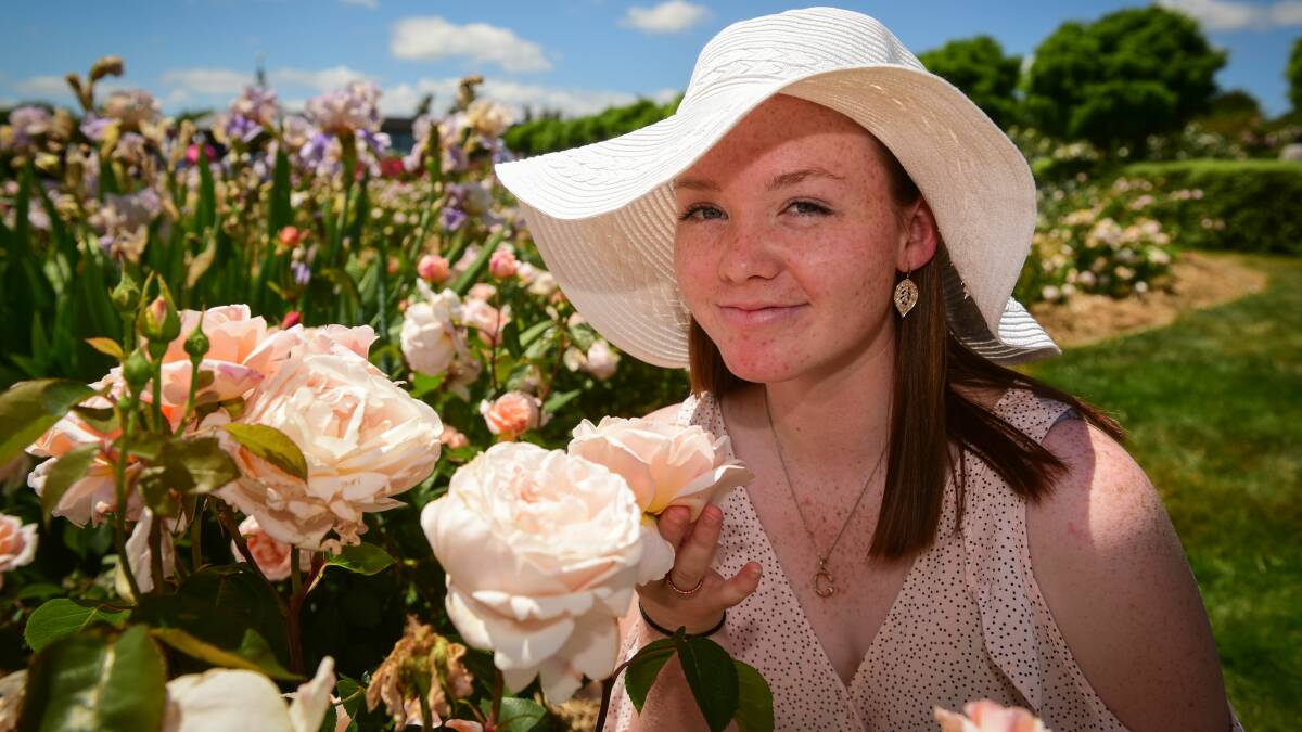 Grace Howard from Trevallyn stops to smell the roses at Sunday's Festival of Roses. Picture: Paul Scambler. 