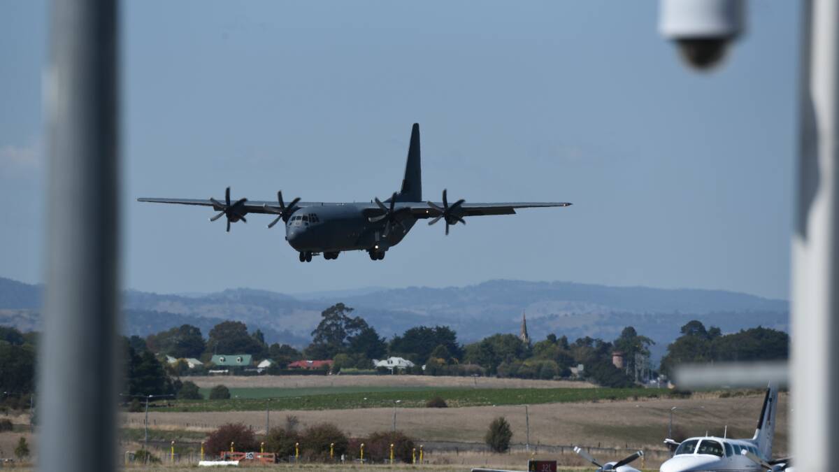 The Hercules touches down at Launceston Airport. 
