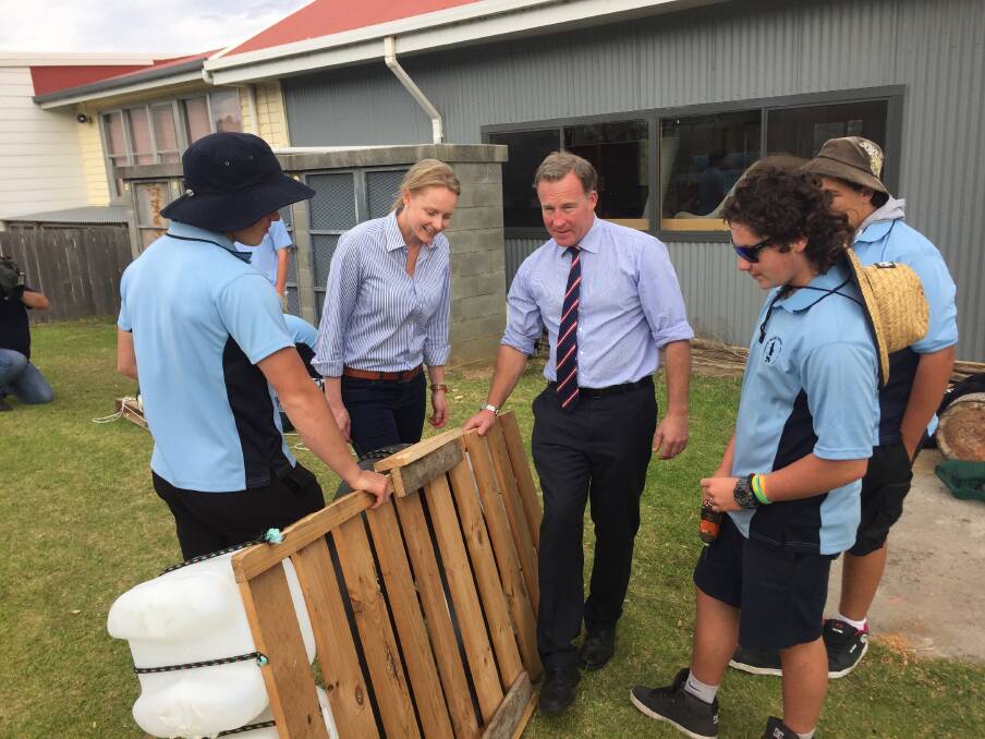 Bass Liberal MHA Sarah Courtney and Premier Will Hodgman observe a raft made by Flinders Island District Island High School students.