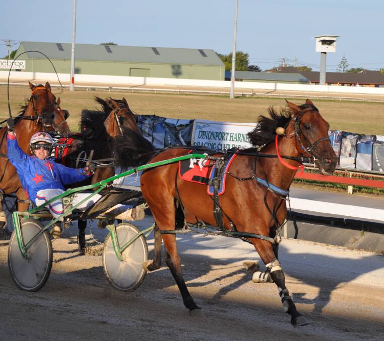 CUPS KING: Driver Mark Yole gives a victory salute as he wins Sunday night's Devonport Cup on Riverboat Jasper. Picture: Greg Mansfield