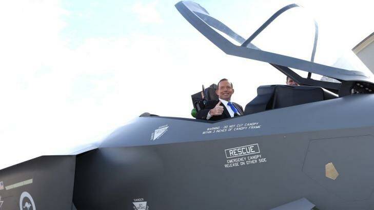 Prime Minister Tony Abbott in the cockpit of of a replica Joint Strike Fighter. Photo: Alex Ellinghausen