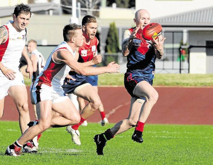 Latrobe's Rodney Coghlan gathers the ball on the run in the Demons' clash against Smithton last week. Picture: NEIL RICHARDSON